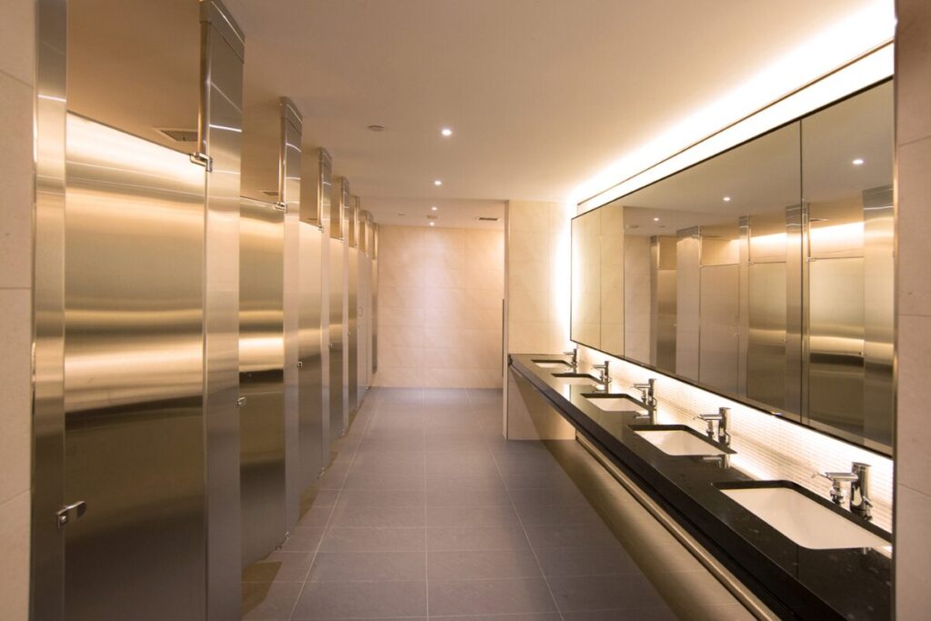 a well lit hotel or restaurant bathroom with elegant, modern features